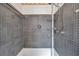 Close up of shower with tiled walls and updated fixtures at 1710 Townsend St, Clearwater, FL 33755