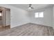Bright bedroom featuring wood-look flooring, a ceiling fan, and a window at 1710 Townsend St, Clearwater, FL 33755