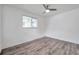 Bright bedroom featuring wood-look flooring, a ceiling fan, and a window at 1710 Townsend St, Clearwater, FL 33755