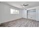 Bright bedroom featuring wood-look flooring, a ceiling fan, and closet at 1710 Townsend St, Clearwater, FL 33755