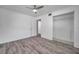 Bedroom featuring wood-look flooring, a ceiling fan, and a spacious closet at 1710 Townsend St, Clearwater, FL 33755