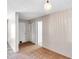 Hallway features ceramic floors, neutral-painted walls and trim, with two white doors, and pendant lighting at 1710 Townsend St, Clearwater, FL 33755