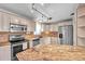Bright kitchen featuring stainless steel appliances, granite countertops and custom lighting at 1710 Townsend St, Clearwater, FL 33755