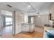 Bright kitchen features a granite island with a track lighting system, ample cabinet storage, and stylish tile floors at 1710 Townsend St, Clearwater, FL 33755