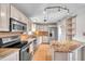 Bright kitchen featuring stainless steel appliances, granite countertops and breakfast bar at 1710 Townsend St, Clearwater, FL 33755