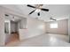 Open-concept living room featuring a view into hallway, tile floors, and ceiling fan at 1710 Townsend St, Clearwater, FL 33755