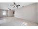 Open-concept living room featuring a ceiling fan, a view into the kitchen, and tile floors at 1710 Townsend St, Clearwater, FL 33755