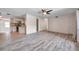 Spacious living room featuring modern light-gray vinyl floors and is connected to the eat-in kitchen at 1710 Townsend St, Clearwater, FL 33755