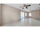 Tile-floored living room with fan and sliding glass doors to screened patio at 1710 Townsend St, Clearwater, FL 33755