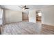 Open-concept living room with updated light-gray flooring, and views into kitchen at 1710 Townsend St, Clearwater, FL 33755