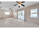 Tile-floored living room featuring fan and sliding glass doors to screened patio at 1710 Townsend St, Clearwater, FL 33755