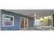 Inviting screened-in porch with a ceiling fan, offering a seamless transition to the backyard and pool area at 1710 Townsend St, Clearwater, FL 33755