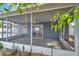 Spacious screened-in porch with ample seating and views of the lush backyard, perfect for relaxation and entertaining at 1710 Townsend St, Clearwater, FL 33755
