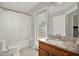 Inviting bathroom featuring a shower and tub combination, a sink with granite countertop, and a large mirror at 18419 Merseyside Loop, Land O Lakes, FL 34638