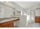 Bright bathroom with granite countertops, wood cabinets, and a walk-in shower at 18419 Merseyside Loop, Land O Lakes, FL 34638