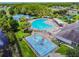 A community pool and splash pad with a tennis court and playground in the background at 18419 Merseyside Loop, Land O Lakes, FL 34638