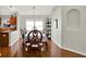 Dining room with a dark wood table and chairs, hardwood floors, and wainscotting at 18419 Merseyside Loop, Land O Lakes, FL 34638