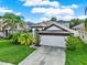 Aerial view of a single Gathering home, showcasing the landscaped yard and two car garage at 18419 Merseyside Loop, Land O Lakes, FL 34638