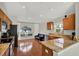 Bright kitchen featuring wood cabinets, granite countertops, and a modern design with a black leather couch at 18419 Merseyside Loop, Land O Lakes, FL 34638