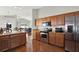 Kitchen with an island, oak cabinets and stainless steel appliances at 18419 Merseyside Loop, Land O Lakes, FL 34638