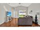 Bright living room with hardwood floors, natural light, and comfortable seating at 18419 Merseyside Loop, Land O Lakes, FL 34638