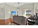 Cozy living room with hardwood floors, a ceiling fan and sliding glass doors at 18419 Merseyside Loop, Land O Lakes, FL 34638