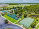 Aerial view featuring a pool, tennis court, playground, and basketball court within the community at 18419 Merseyside Loop, Land O Lakes, FL 34638
