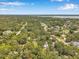 Aerial view of the neighborhood showcasing houses surrounded by lush greenery, offering a serene and private setting at 2140 Bow Ln, Safety Harbor, FL 34695
