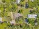 Aerial top-down view of the home, showcasing the layout of the house, detached garage, and landscaping at 2140 Bow Ln, Safety Harbor, FL 34695