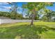 Spacious backyard features a well-manicured lawn and a white fence for added privacy at 2140 Bow Ln, Safety Harbor, FL 34695