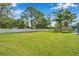 Extensive backyard surrounded by a white fence, offering ample space for recreation and privacy at 2140 Bow Ln, Safety Harbor, FL 34695
