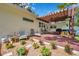 Relaxing backyard deck featuring a pergola, seating, and beautiful landscaping, perfect for outdoor enjoyment at 2140 Bow Ln, Safety Harbor, FL 34695