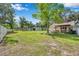 Expansive backyard with a well-maintained lawn, detached garage, and a white privacy fence at 2140 Bow Ln, Safety Harbor, FL 34695