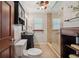 Cozy bathroom featuring a vanity, toilet, and a glass-enclosed shower with beige tile at 2140 Bow Ln, Safety Harbor, FL 34695