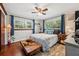 Charming bedroom with hardwood floors, large windows, and nautical-themed decor at 2140 Bow Ln, Safety Harbor, FL 34695