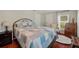 Cozy bedroom featuring a queen-sized bed, classic dresser, and hardwood floors at 2140 Bow Ln, Safety Harbor, FL 34695