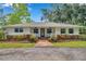 Inviting single-story home with landscaped front yard, a cozy porch, and beautiful curb appeal at 2140 Bow Ln, Safety Harbor, FL 34695