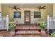 Cozy front porch with ceiling fans, chairs, and decorative plants create a relaxing outdoor space at 2140 Bow Ln, Safety Harbor, FL 34695