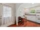 Bright kitchen with white cabinets, hardwood floors, table and door to the left at 2140 Bow Ln, Safety Harbor, FL 34695