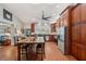 Bright and airy kitchen featuring a large island, stainless steel appliances, and dark wood cabinets at 2140 Bow Ln, Safety Harbor, FL 34695