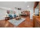 Open-concept living room with hardwood floors seamlessly connected to the kitchen and dining area, ideal for entertaining at 2140 Bow Ln, Safety Harbor, FL 34695