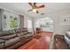 Cozy living room leading into a kitchen with wood floors and inviting decor at 2140 Bow Ln, Safety Harbor, FL 34695
