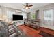 Inviting living room with wood floors, leather couches, and window views at 2140 Bow Ln, Safety Harbor, FL 34695