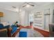 Comfortable living area with bookshelves, a blue chair, and hardwood floors at 2140 Bow Ln, Safety Harbor, FL 34695