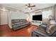 Spacious living room featuring wood floors, comfortable seating, ceiling fan, and natural light at 2140 Bow Ln, Safety Harbor, FL 34695