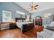 Serene main bedroom with vaulted ceilings, hardwood floors, a fireplace, and plenty of natural light at 2140 Bow Ln, Safety Harbor, FL 34695
