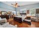 Bright bedroom features hardwood floors, vaulted ceilings, and a king-size bed with plush pillows at 2140 Bow Ln, Safety Harbor, FL 34695