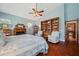 Spacious bedroom features vaulted ceiling, fireplace, and a wooden bookcase filled with collectibles at 2140 Bow Ln, Safety Harbor, FL 34695