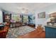 Well-lit office space with hardwood floors, a ceiling fan, a desk, and exercise equipment at 2140 Bow Ln, Safety Harbor, FL 34695