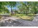 Expansive front yard with mature trees providing ample shade and privacy to the home at 2140 Bow Ln, Safety Harbor, FL 34695